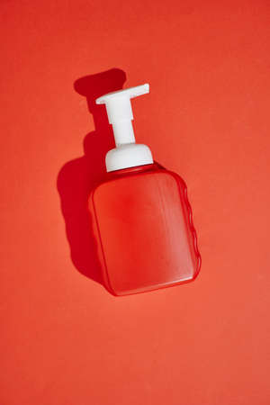 A studio photo of a mobile phone with headphonesの写真素材