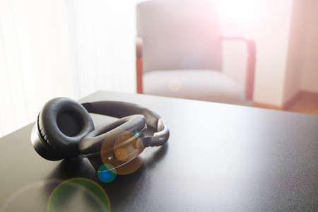 A studio photo of black headphonesの写真素材
