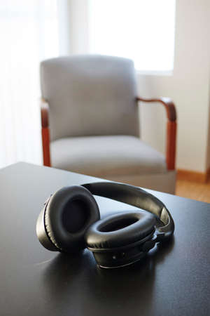 A studio photo of black headphonesの写真素材