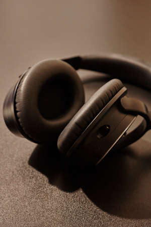 A studio photo of black headphonesの写真素材