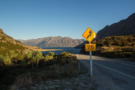 landscape view of road in front of beautiful lake hawea in new zealand south islandの写真素材