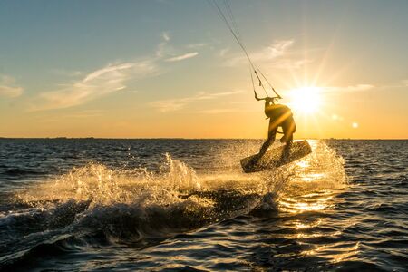 kitesurfer doing tricks in sunsetの写真素材