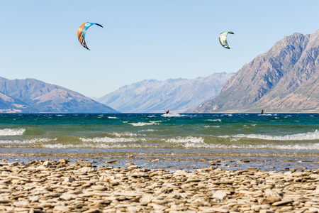 Kitesurfer in front of beautiful mountain scenery at lake hawea in New Zealand south islandのeditorial素材