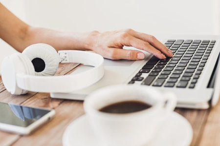 Place of work. Young adult using laptopの写真素材