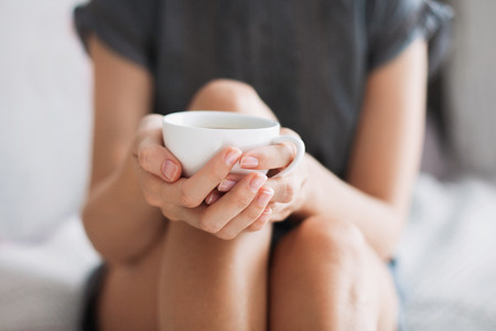 Woman holding cup of coffeeの写真素材