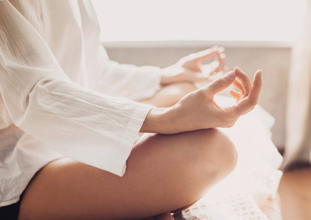 Woman meditating in the lotus position closeupの写真素材