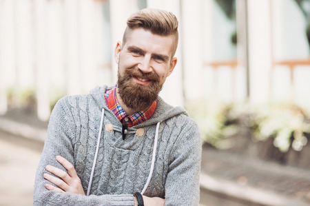 Cheerful young man wearing warm clothes outdoorsの写真素材