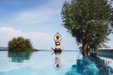 Young woman practicing yoga outdoors. Meditation balance relaxation conceptの写真素材