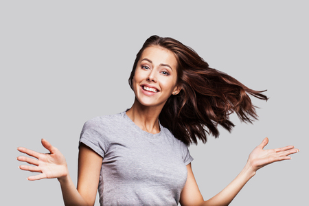 Pretty girl with long hair laughing, dancing and enjoying lifeの写真素材