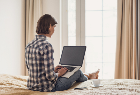 Young girl using laptop computer at homeの写真素材