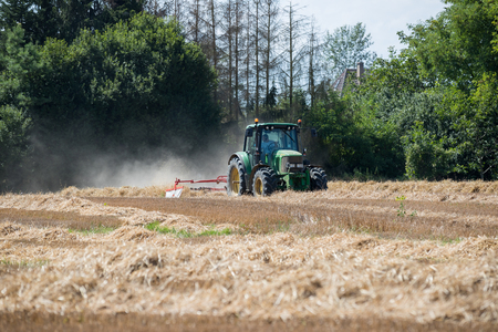 Agricultural tractor in activity in the fieldsのeditorial素材