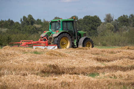 Agricultural tractor in activity in the fieldsのeditorial素材