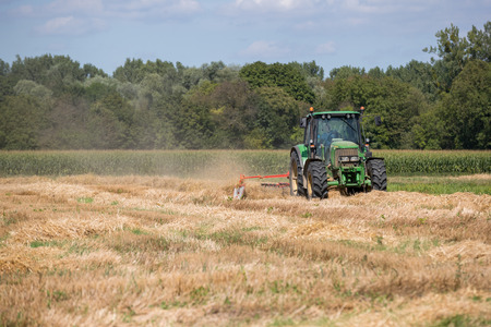 Agricultural tractor in activity in the fieldsのeditorial素材