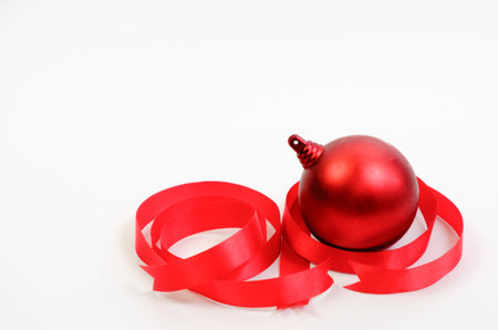 Red Christmas ball and ribbon on white backgroundの写真素材