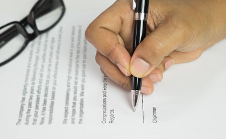 Blurred of letter on congratulation document, Hand signing in a letter.の写真素材