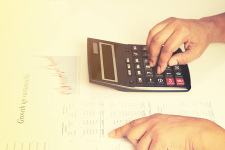 Hand of accountant checking financial documentの写真素材