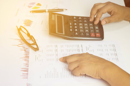 Hand of accountant checking financial documentの写真素材