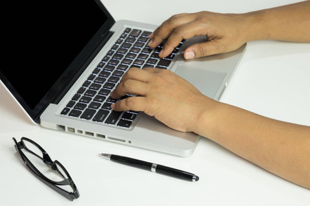 Closeup of hands typing on laptop computerの写真素材