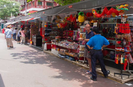 SINGAPORE - April 8, 2019: Chinatown with notable Chinese buildings, restaurants and decoration, authentic food, clothes and other stuff and people engaging in daily activity.のeditorial素材