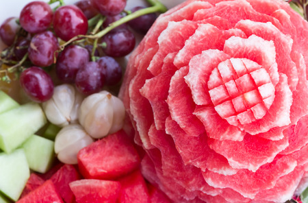Watermelon carvings on a plate and famous tropical fruits cut professionallyの写真素材