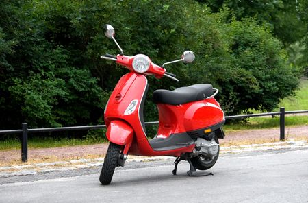 One Red Scooter in the Parkの写真素材