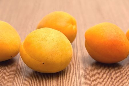 Ripe Orange Apricots on the Wood Surfaceの写真素材