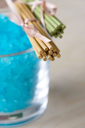 Blue bath salt in glass and aromatic sticksの写真素材