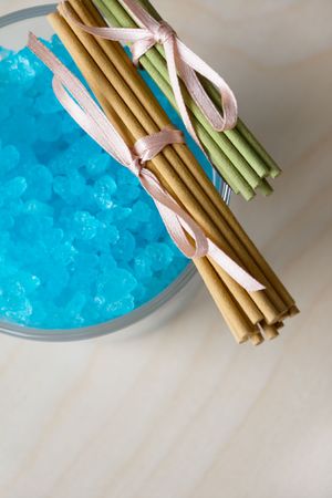 Blue bath salt in glass and aromatic sticksの写真素材
