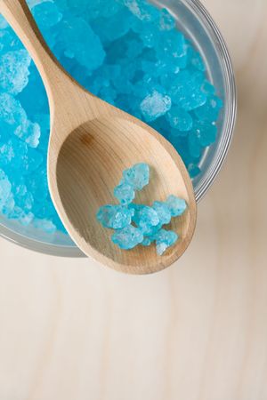 Blue bath salt in glass and wood spoonの写真素材