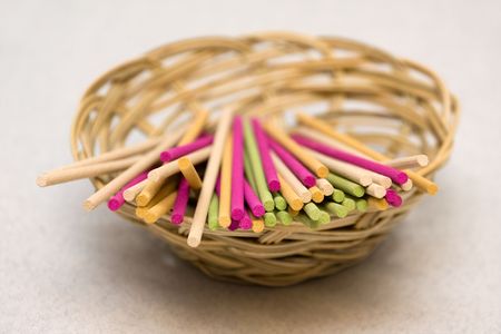 Colored aromatic sticks in basketの写真素材