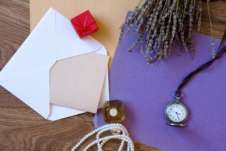 Paper composition with perfume bottle, gift box, lavender and pocket watchの写真素材