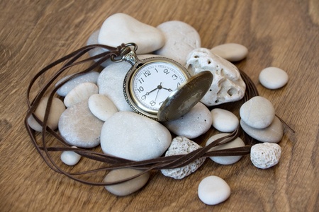Pocket watch and handful of stonesの写真素材