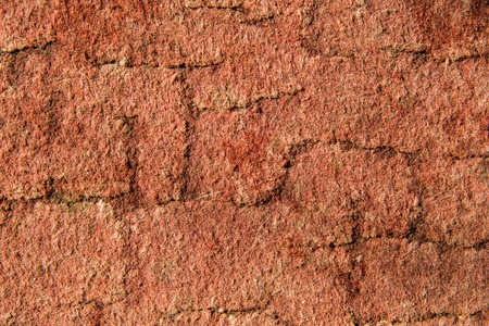 Texture of dry red clay with stones close-upの写真素材