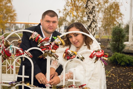 Newly married couple posing in autumn parkの写真素材