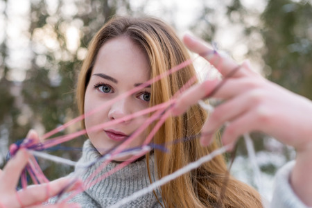 Hipster Girl in Knitted Sweater with a ball of woolの写真素材
