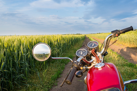 Summer landscape road, wheat field and clouds. Motorcycleの写真素材