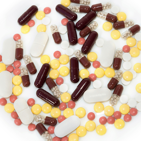 Colored pills on whiteの写真素材