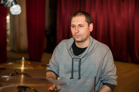 Musician playing drums on stageの写真素材