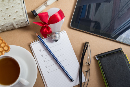 Mix of office supplies and business gadgets on office deskの写真素材