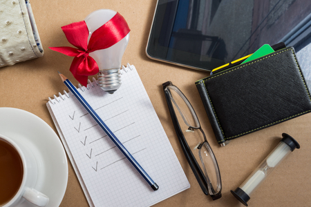 Mix of office supplies and business gadgets on office desk.の写真素材