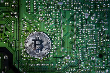 Silver Bitcoins on the chip. The green background. Crypt Of Safetyの写真素材
