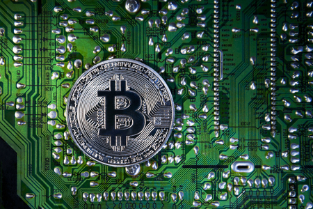 Silver Bitcoins on the chip. The green background. Crypt Of Safetyの写真素材
