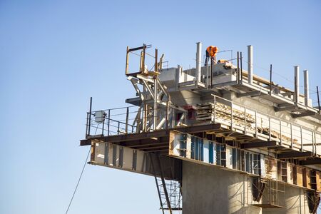Bridge construction manual labor, the place of workers on tall polesの写真素材