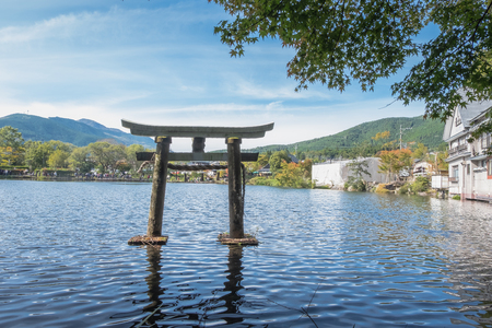 Lake Kinrin and Japanese gate (Torii) with Mount Yufu and blue sky background at Yufuin, Oita, Kyushu, Japanのeditorial素材