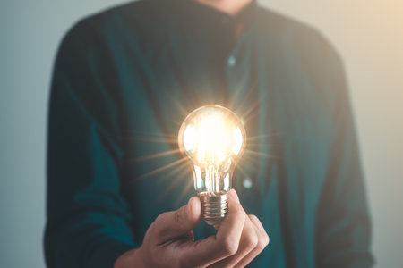 Business man holding light bulb. New idea, innovation technology and creative concept.の写真素材