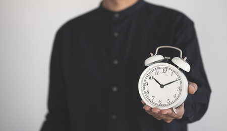 Time managment concept. Business man hold the clock . Work management.の写真素材