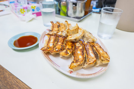Japanese dumpling or Gyoza on the white plate with soy sauceの写真素材
