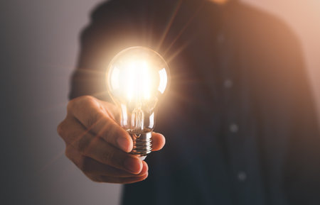 Business man holding light bulb. New idea, innovation technology and creative concept.の写真素材