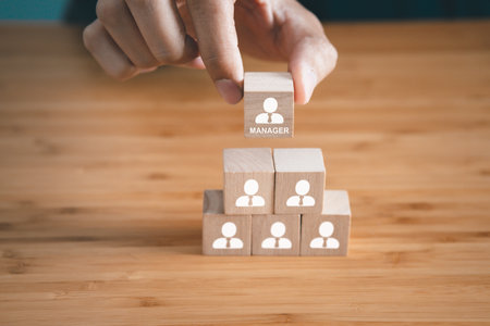 Wooden block with employee icons. Manager is on the top of employees. Business, company organization and teamwork concept.の写真素材