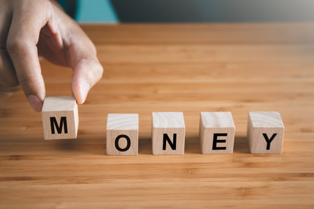 Businessman hold wooden block with  money text. money and finance conceptの写真素材